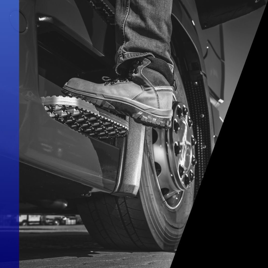 Close-up of a person's boot stepping on the running board of a semi-truck, representing a truck driver needing mobile repair or roadside assistance.