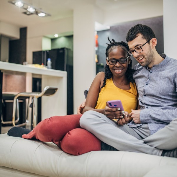 couple sitting together using a phone