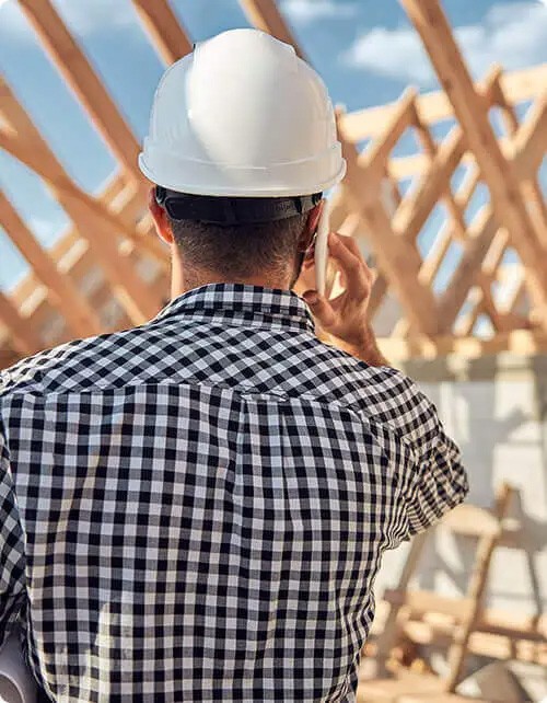 young-contractor-in-a-hard-hat-talking-on-the-phone.jpg