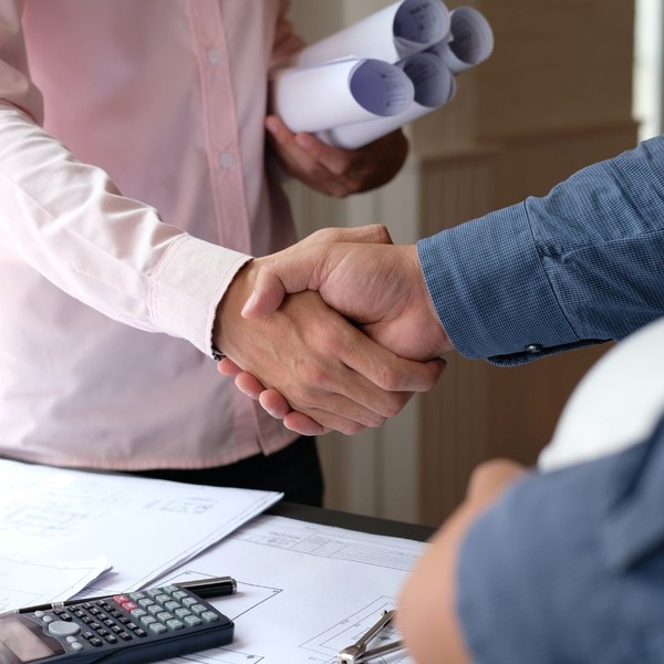 Contractor shaking hands with client