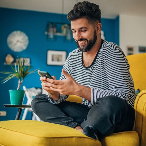 Man smiling at his phone