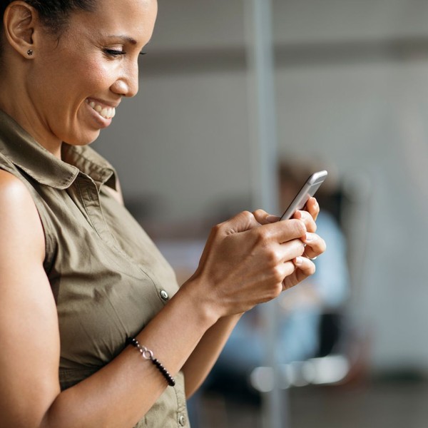 Woman smiling at her phone