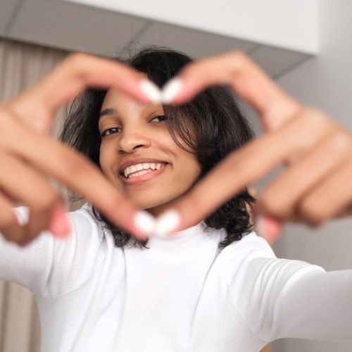 girl making heart hands