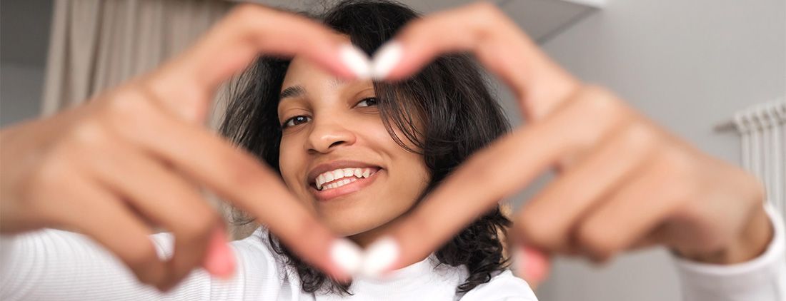 girl making heart with her hands