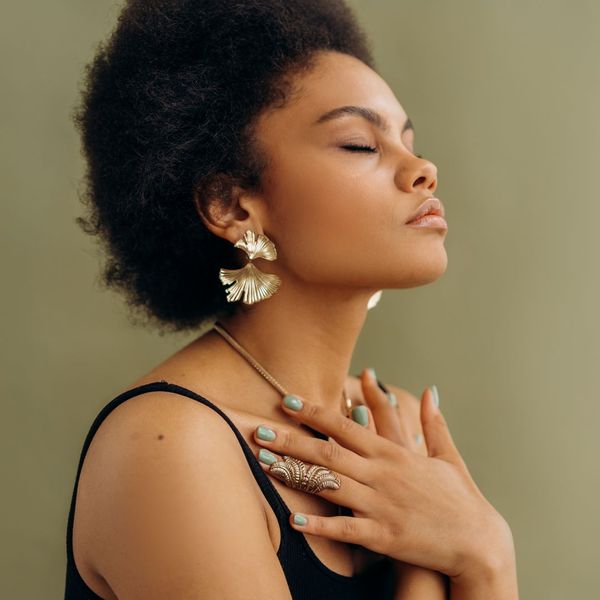 a beautiful African American woman that's relaxed with hands crossed on her chest and breathing in slowly image1.jpg