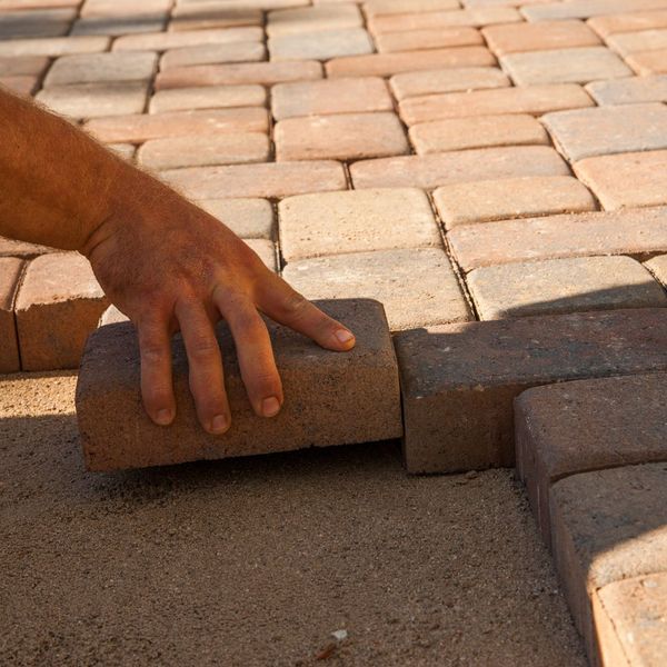 person laying pavers