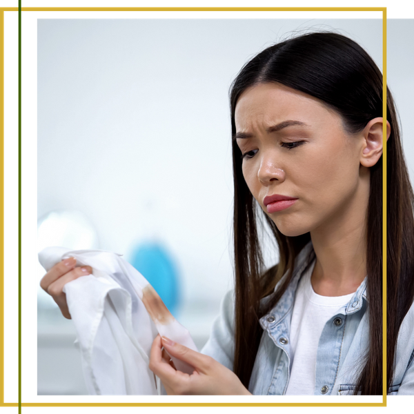 upset woman looking at stain on white shirt upset woman looking at stain on white shirt