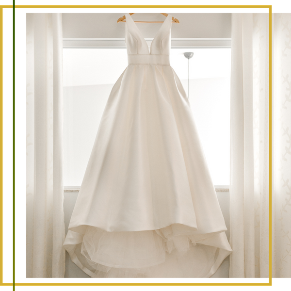 wedding dress hung in windowsill