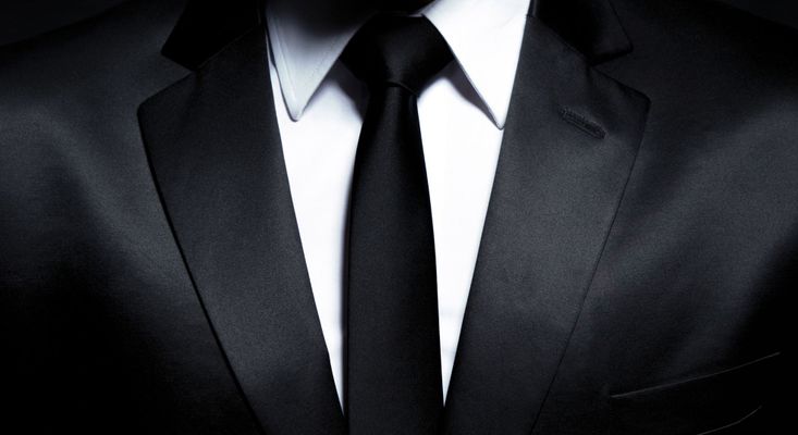 up close view of black suit and tie