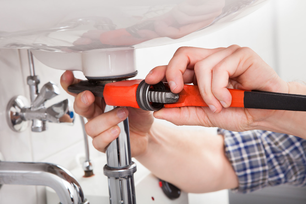 maintenance man repairing sink
