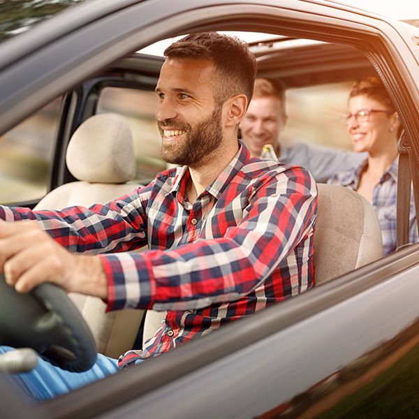 happy driver and backseat passengers