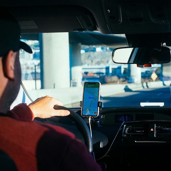 view of driver and navigation phone from backseat