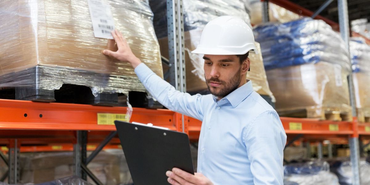 man looking at clipboard in warehouse