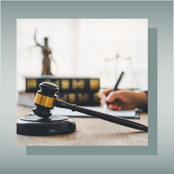 Judge’s gavel on desk with legal books in background