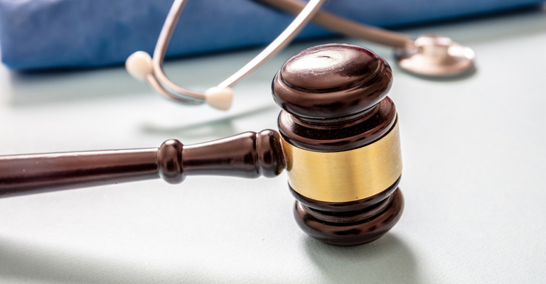 A gavel and law book on a wooden desk, symbolizing justice in a personal injury case.