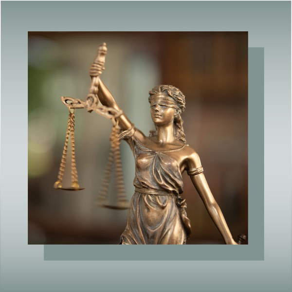 Blindfolded Lady Justice holding scales, symbolizing fairness and law