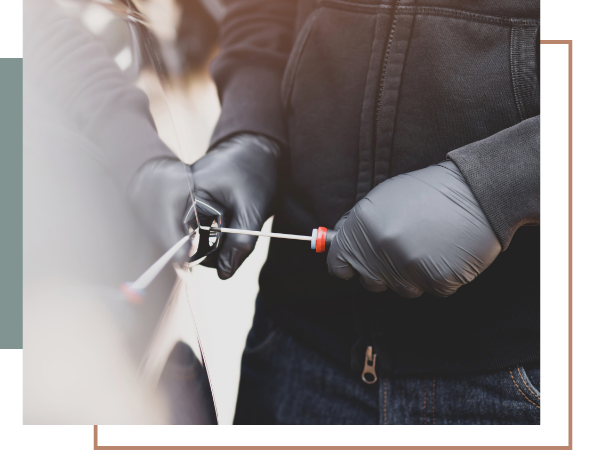 a man using a screwdriver to break into a car