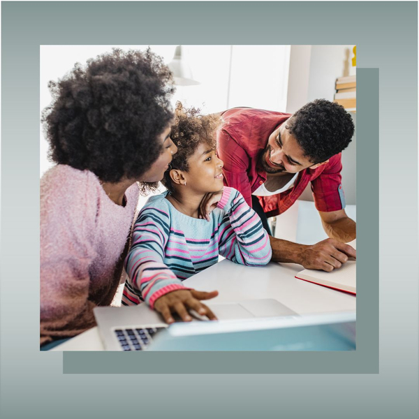 Smiling family of three working together on a laptop