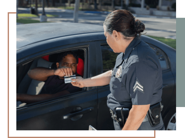 Police officer taking a driver license during a traffic stop for a reckless driving speeding violation