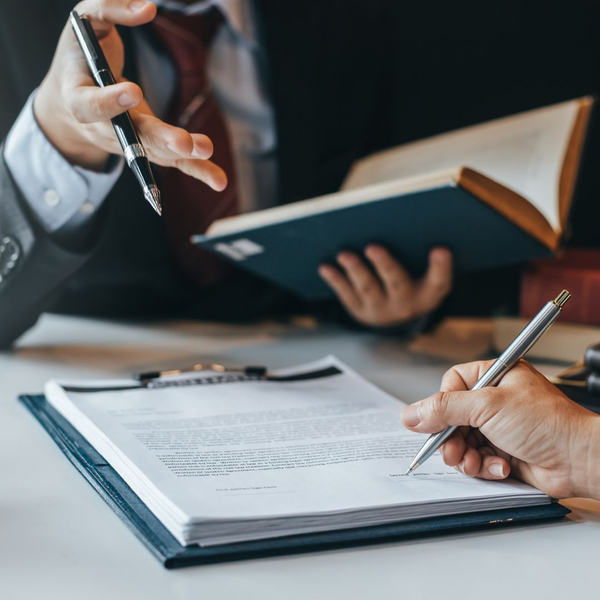 attorney talking while client signs paperwork