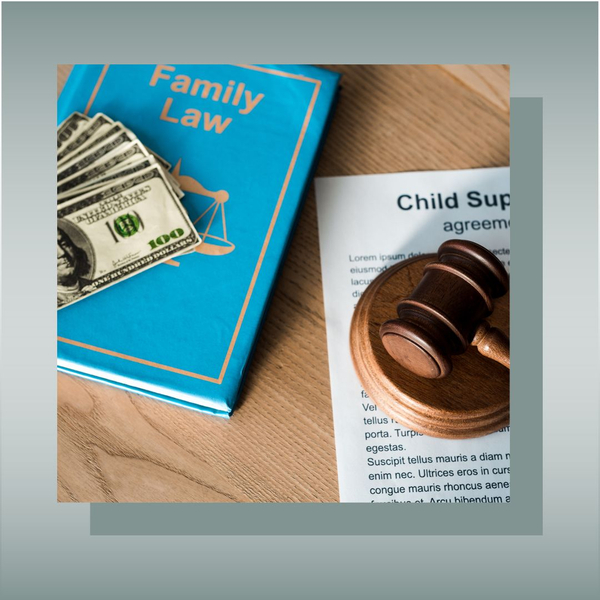 Family law book, cash, and child support agreement with gavel