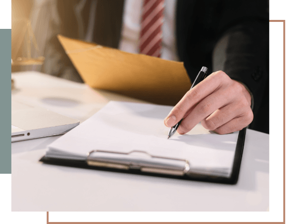 Attorney filling out legal paperwork on a clipboard to build a reckless driving defense strategy