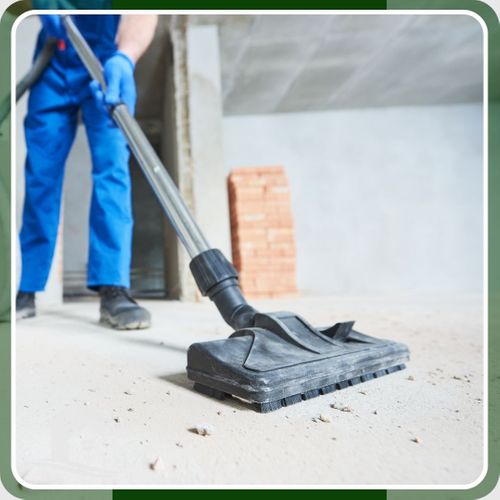 man vacuuming construction dust