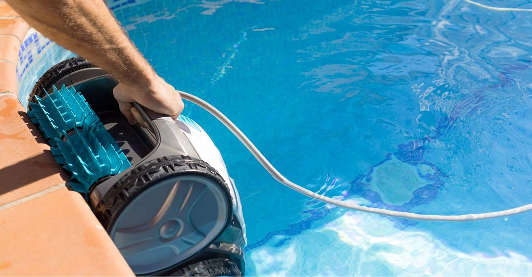 a person cleaning a pool