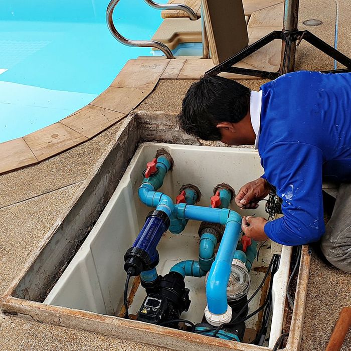 a person working on pool pipes