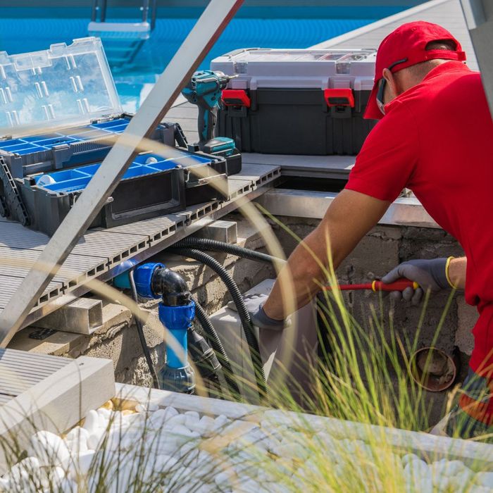 pool serviceman conducting pool maintenance