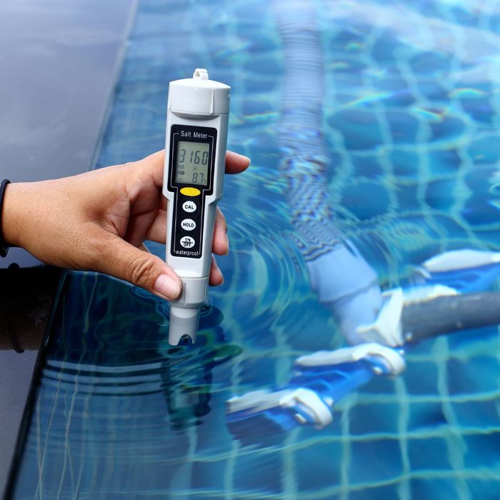  a person testing pool water