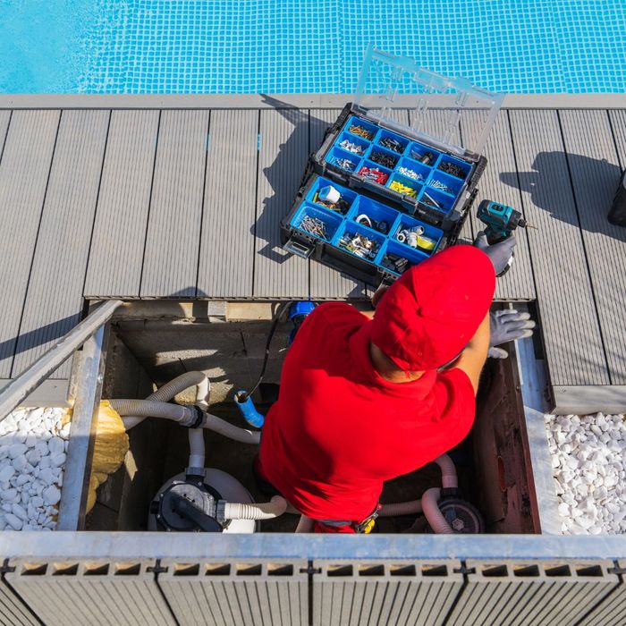 pool serviceman updating outdated equipment