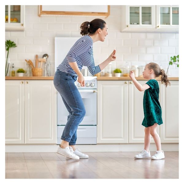 mother and daughter dancing in remodeled kitchen