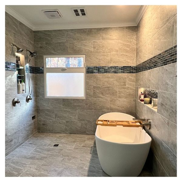 remodeled shower with tile wall and large soaking tub