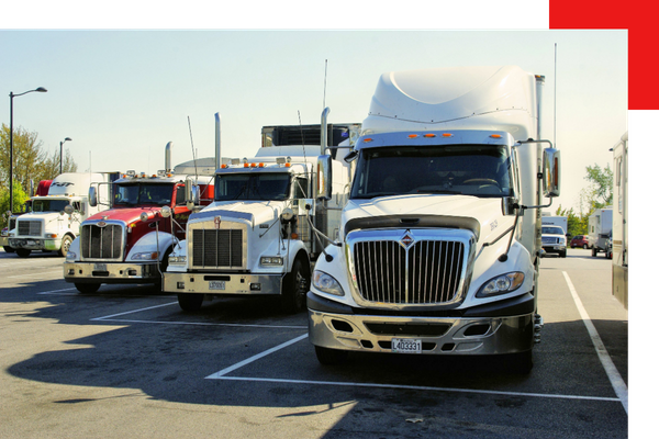 a parking lot of semi trucks