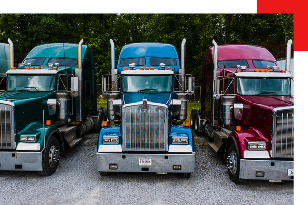 3 semi trucks parked in a row