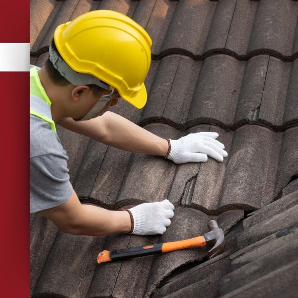 inspecting a broken roof tile