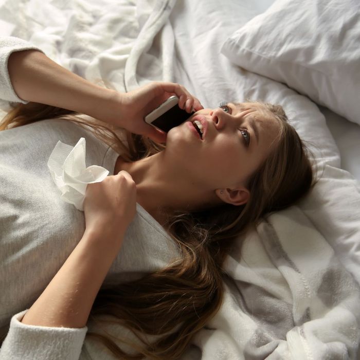 a woman on a bed crying on the phone