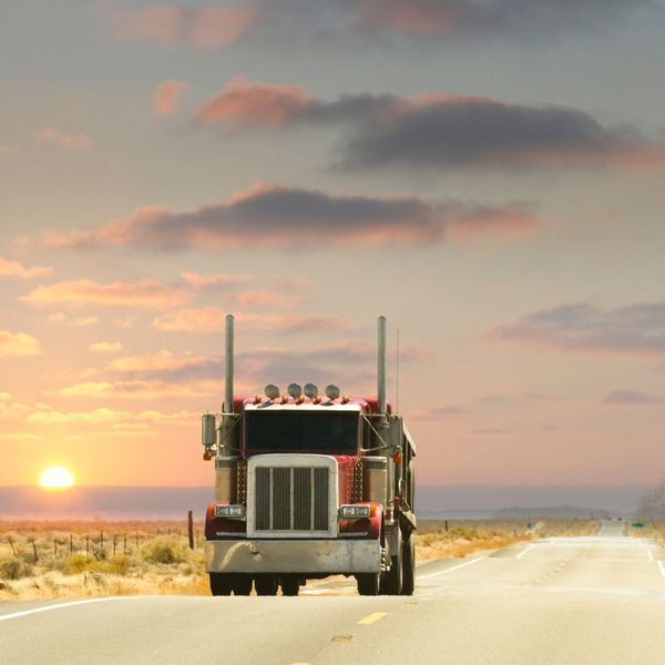 truck driving at sunset