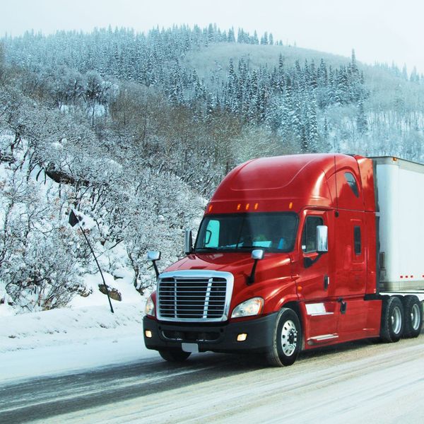 semi truck driving on an icy road
