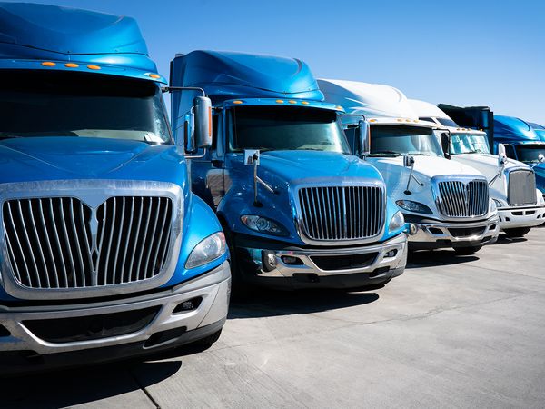 fleet of semi trucks in blue and white