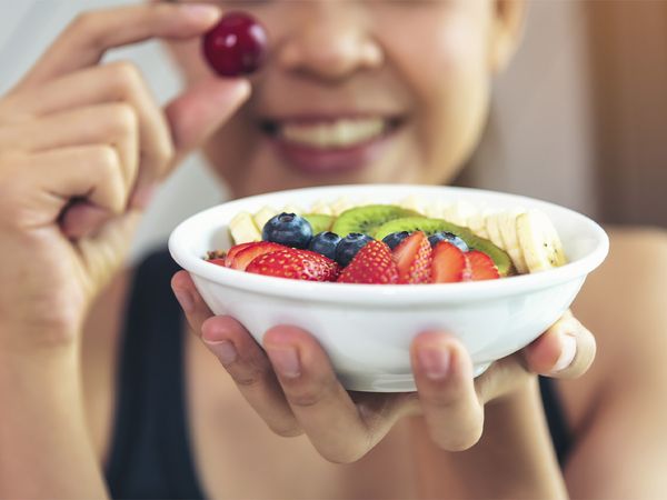 A woman eating healthy fruits