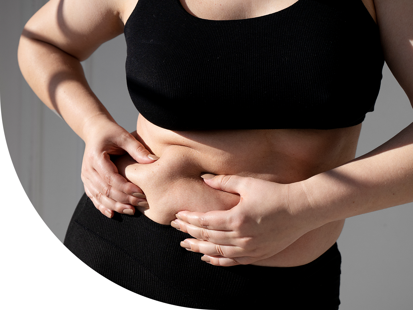 image of a woman pinching stomach