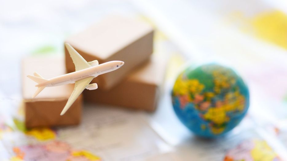 small model plane with boxes and globe
