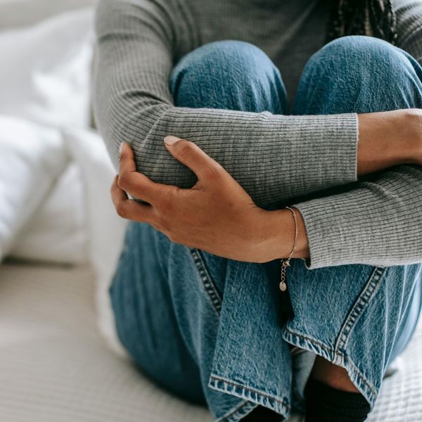 girl holding her knees against her chest