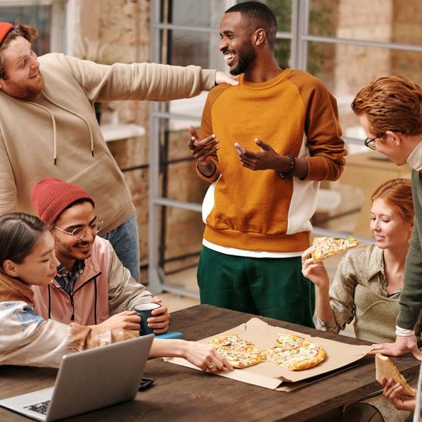 friends spending time together enjoying pizza friends spending time together enjoying pizza