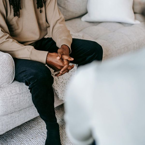 sitting on couch speaking with counselor sitting on couch speaking with counselor