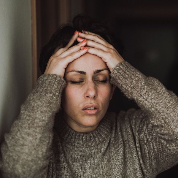 worried woman holding hands to head