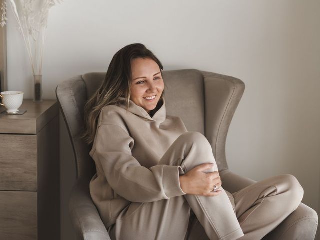 woman smiling in relief sitting in a chair