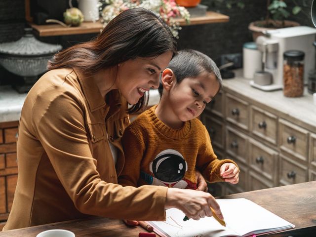 mother smiling and coloring with her autistic child